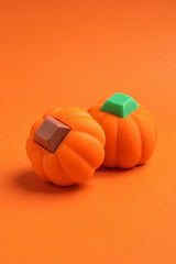Two 3D printed pumpkin keyboard fidgets, one with a green keycap and one with a brown keycap