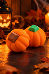 Two pumpkin keyboard fidgets with green and brown keycaps in a Halloween scene